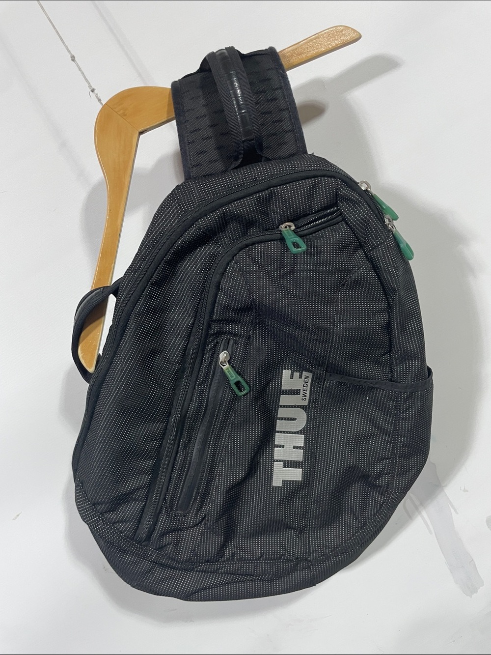 Thule Black Sling Backpack with Green Zipper Accents
